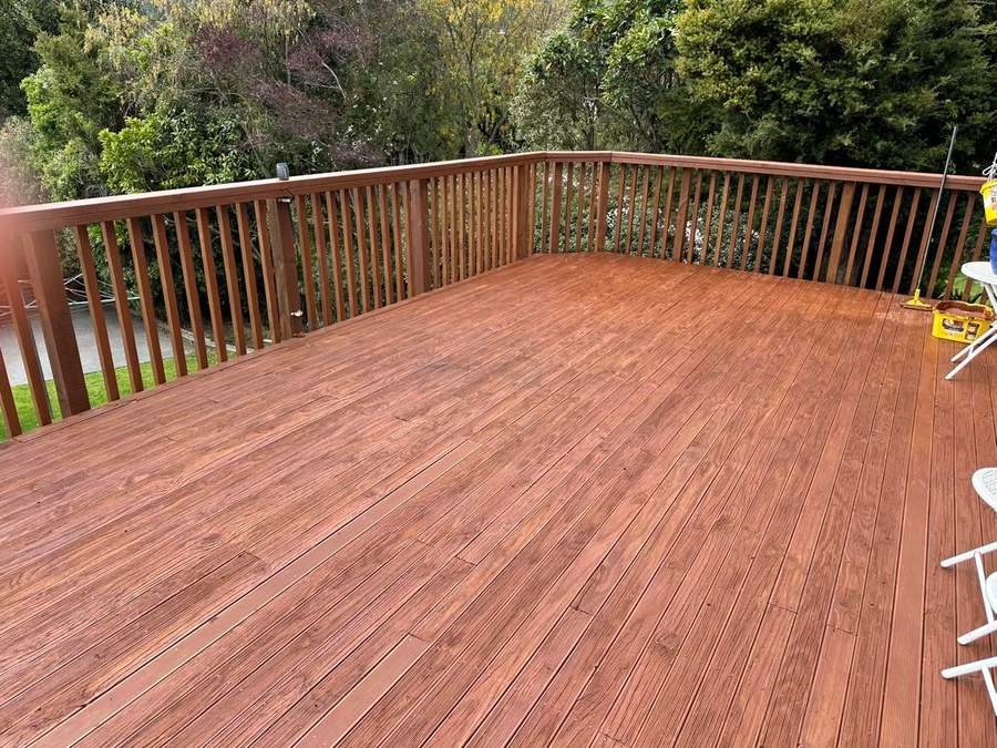 Deck after water blasting and restaining, warm brown finish