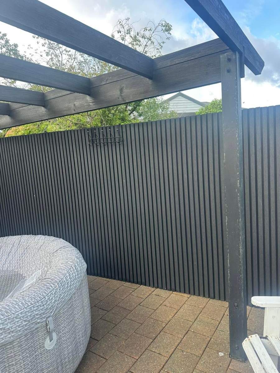 Composite fencing installed under a pergola