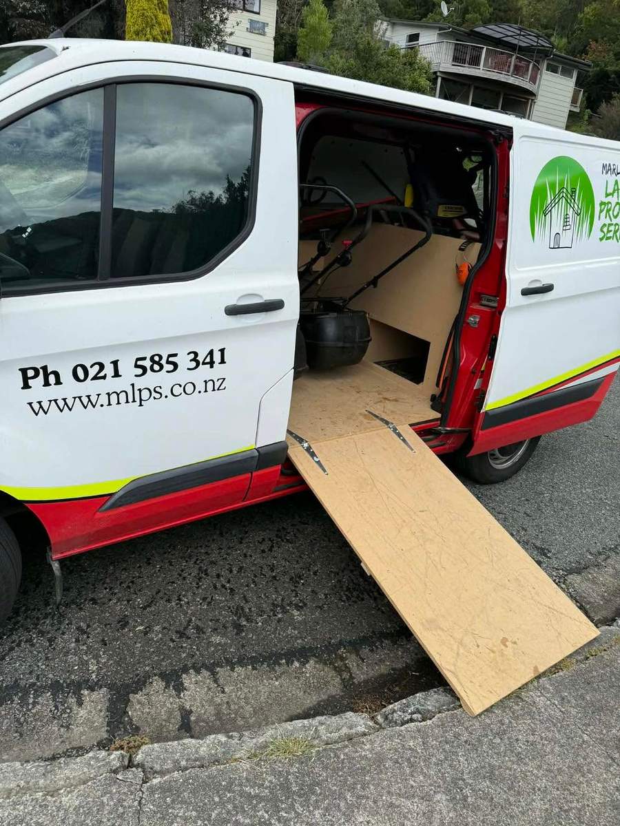 Van loaded with mowing and property care equipment